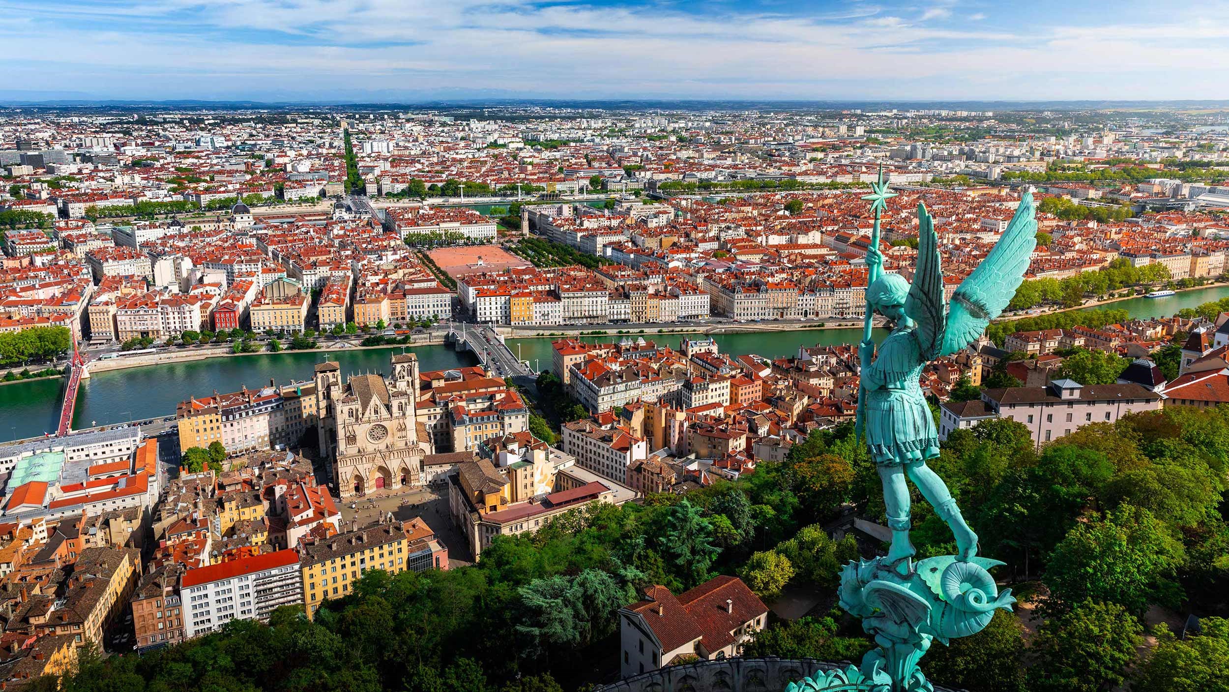 Lyon cityscape with Archangel Michael statue and Saône River