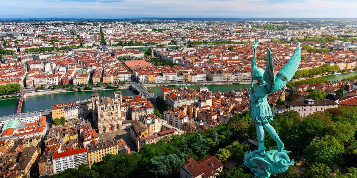 Lyon cityscape with Archangel Michael statue and Saône River