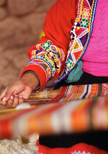 Hand of Peruvian weaver preparing traditional fabric