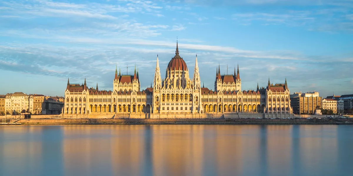 Hungarian Parliament in Budapest, reflected in a beautiful orange-hued river