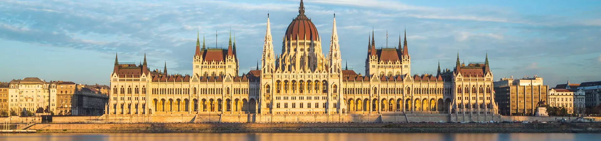 Hungarian Parliament in Budapest, reflected in a beautiful orange-hued river