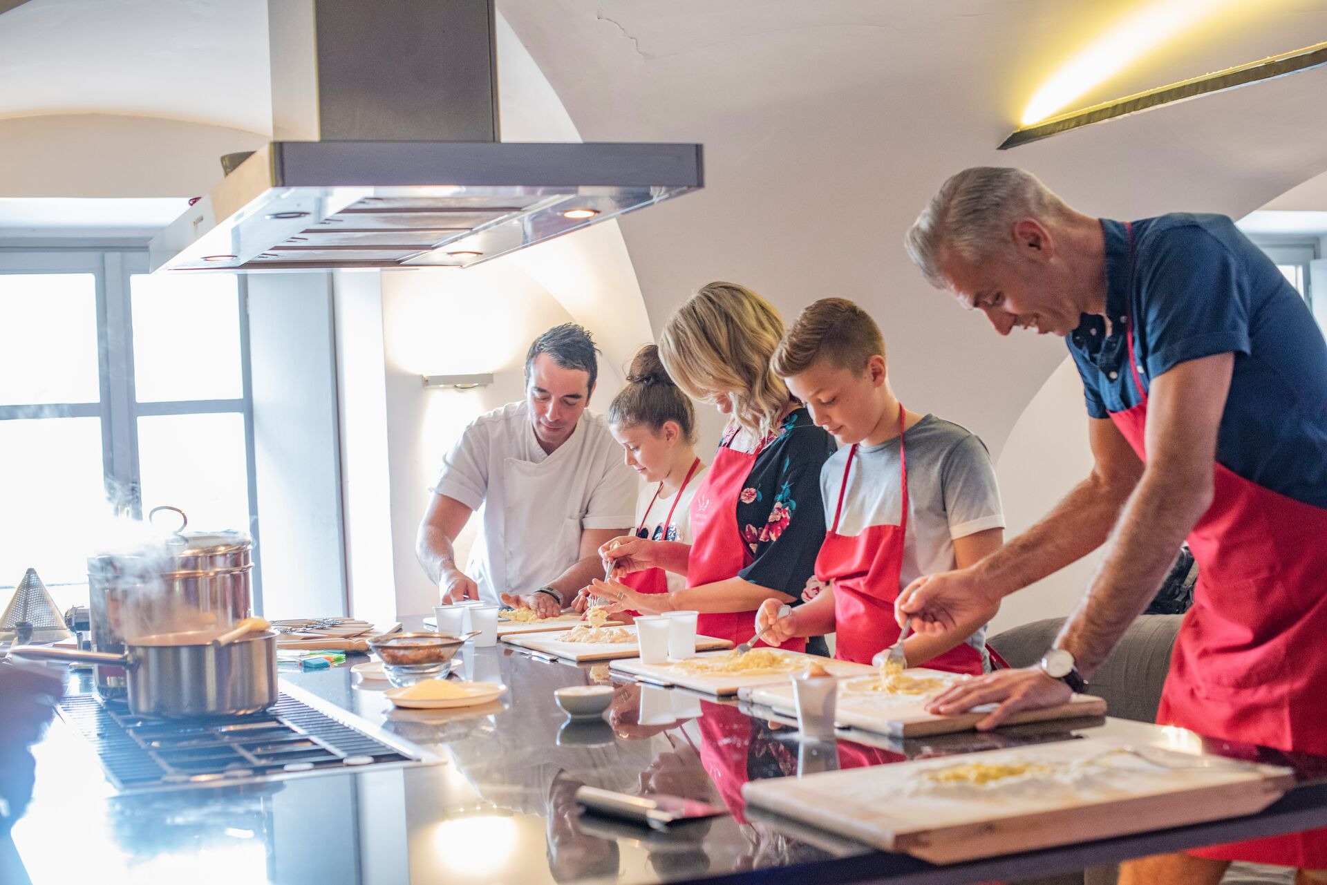 Family on pasta making experience in Italy