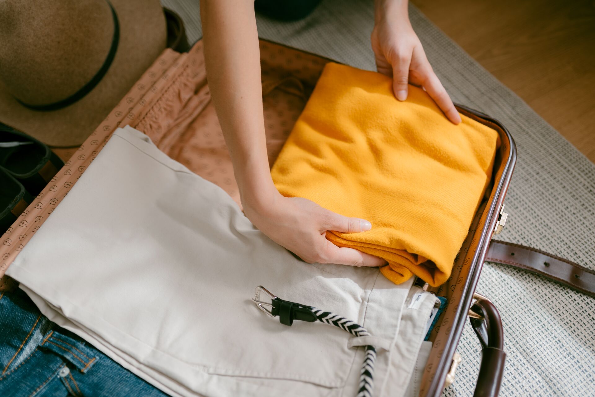 Aerial view of a woman packing a suitcase