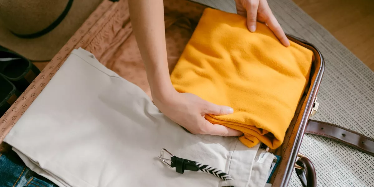 Aerial view of a woman packing a suitcase