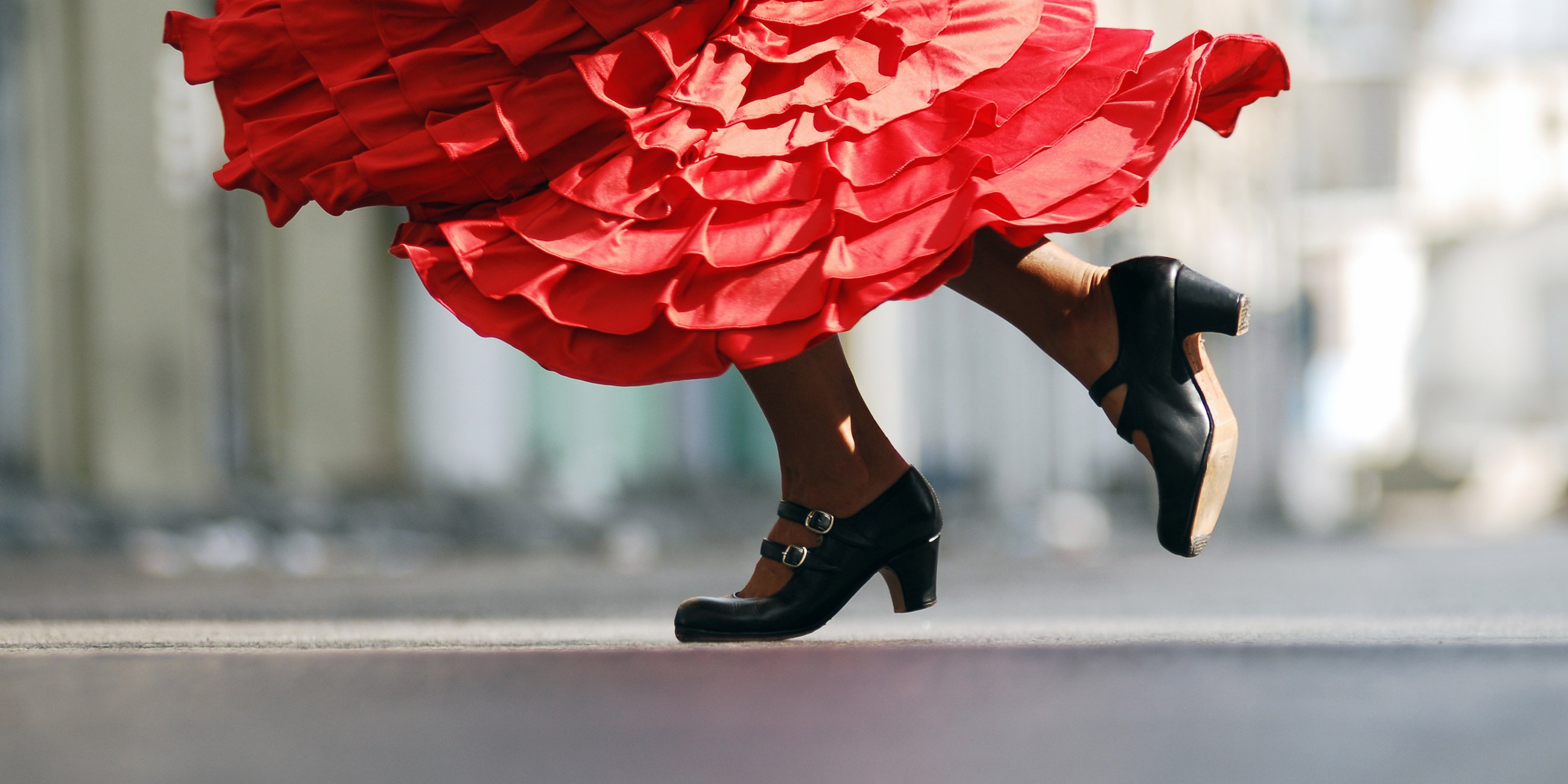 Woman in red dress dancing flamenco in Spain