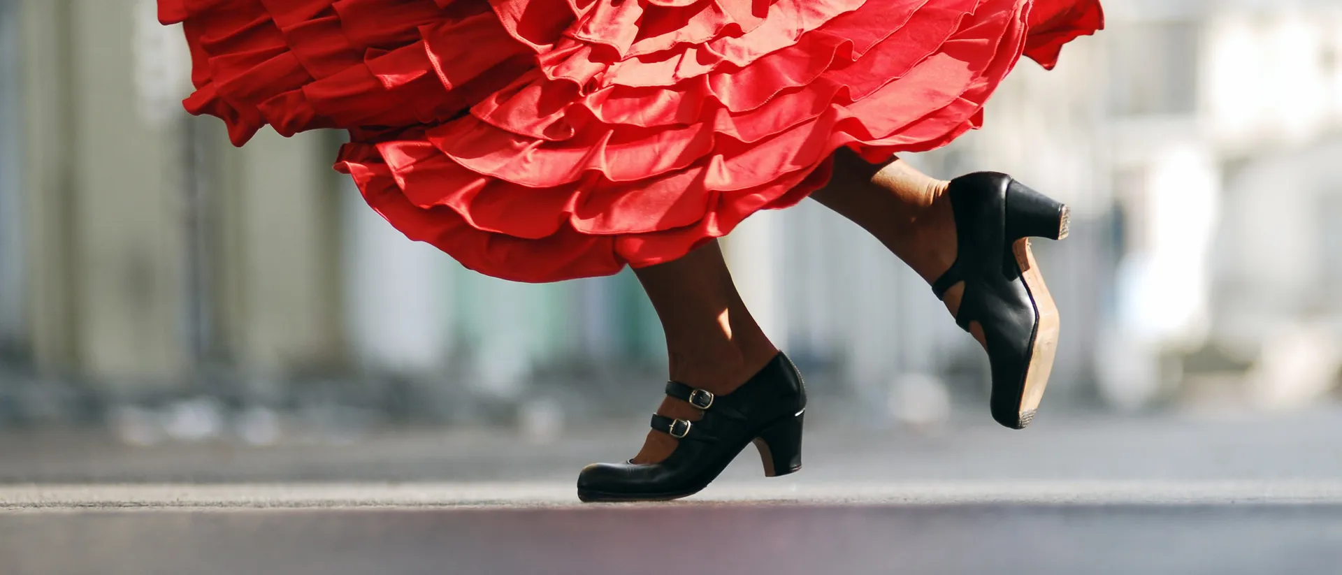 Woman in red dress dancing flamenco in Spain