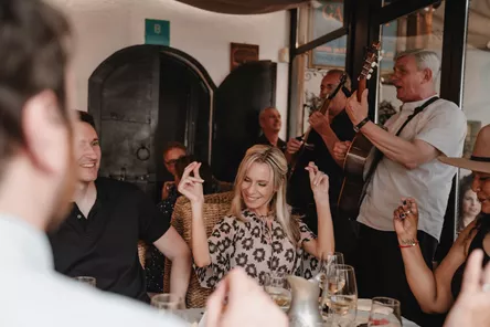 Guests dancing to traditional music while in restaurant in Bosnia