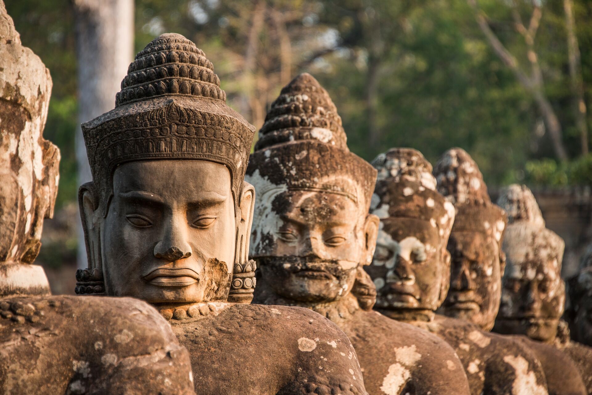 Sculptures at South Gate of Angkor Thom Temple in Archaeological Park in Cambodia