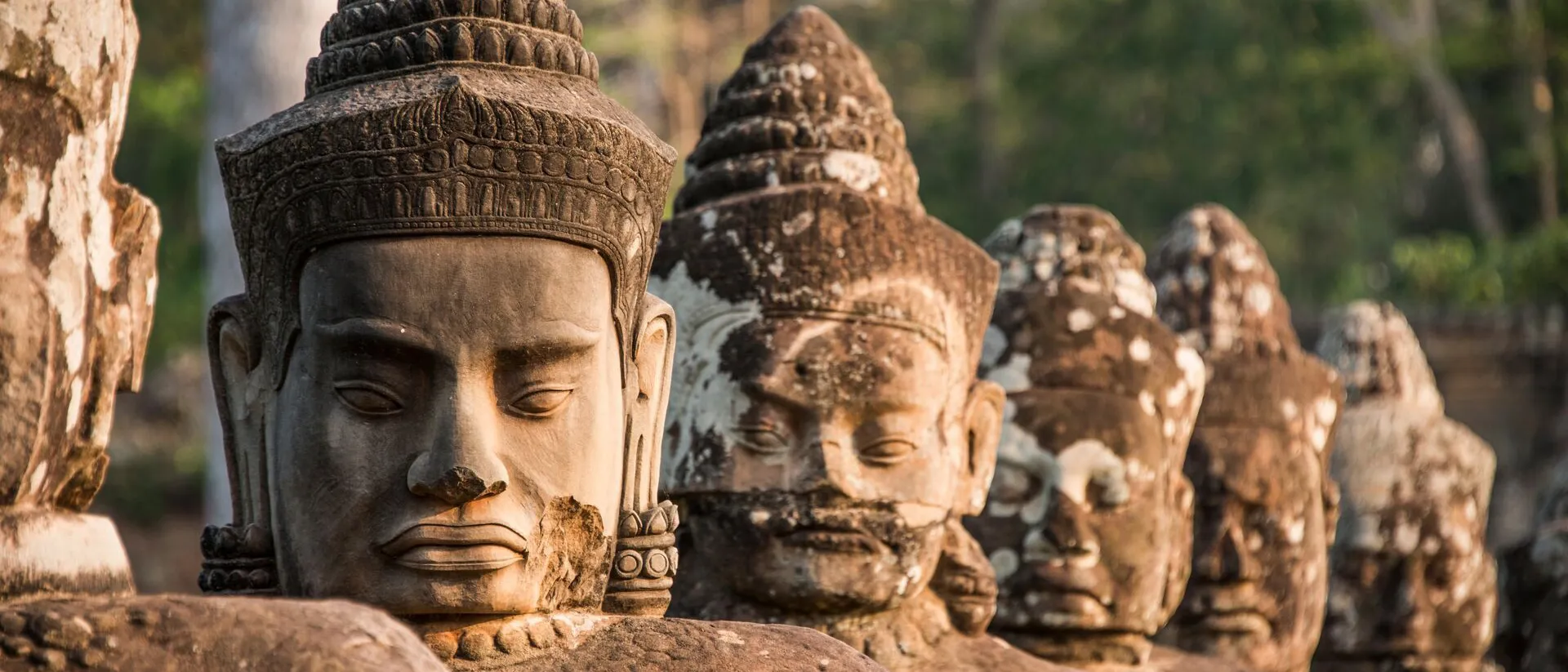 Sculptures at South Gate of Angkor Thom Temple in Archaeological Park in Cambodia