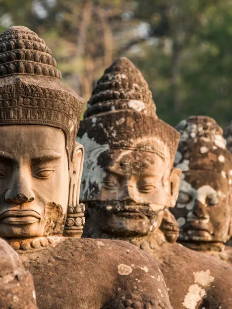 Sculptures at South Gate of Angkor Thom Temple in Archaeological Park in Cambodia