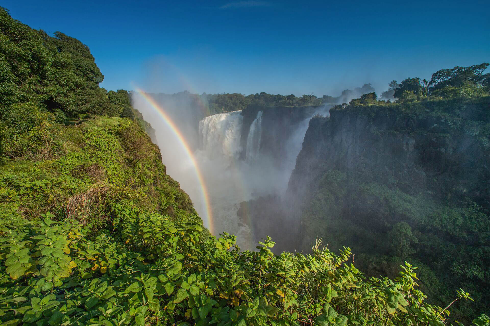 View of Victoria Falls and a rainbow on the sky