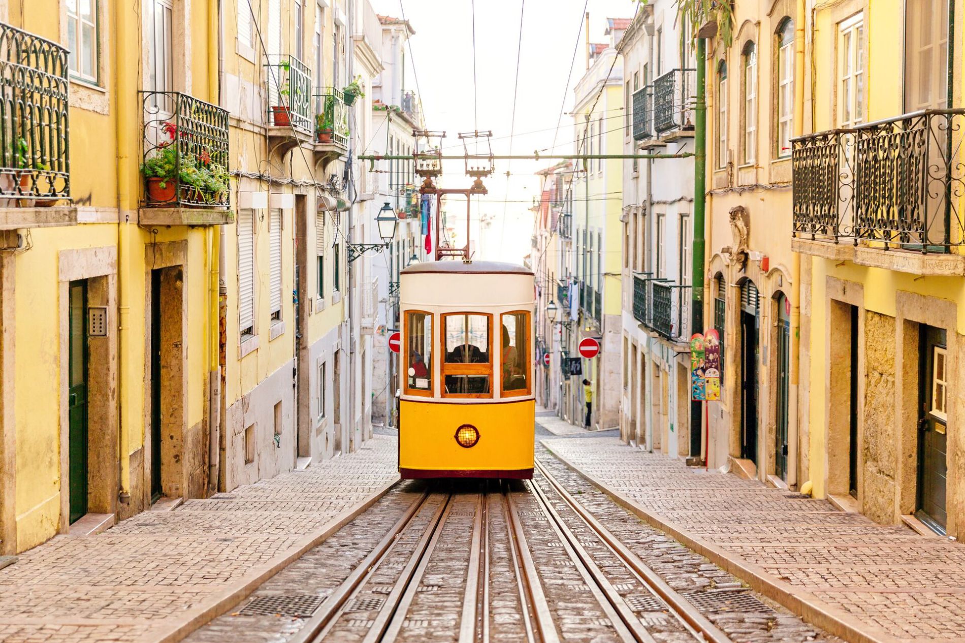 Large Elevador Da Bica Funicular between rows of old traditional houses in Lisbon, Portugal 