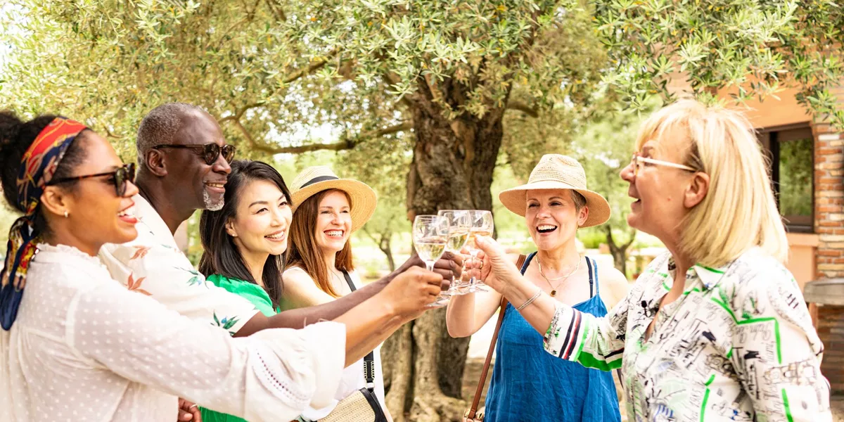 Guests holding up drinks at a Be My Guest experience