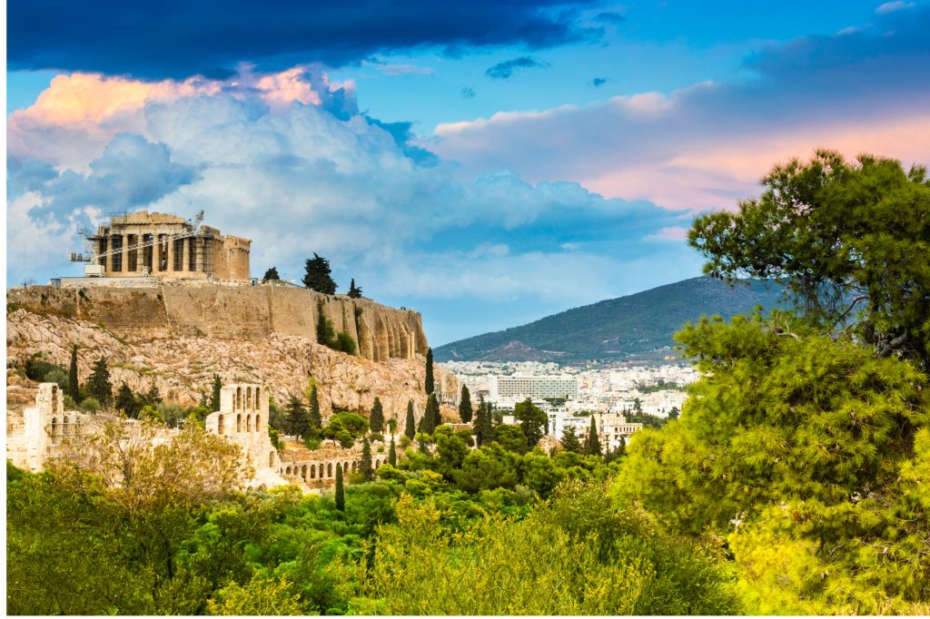 budget-friendly destinations in europe. Ancient ruins of the Acropolis on the hill, with greenery all around it.