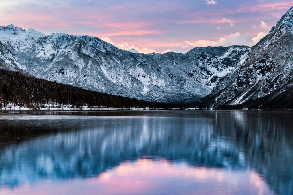Reflective shot of mountains surrounding Lake Bled