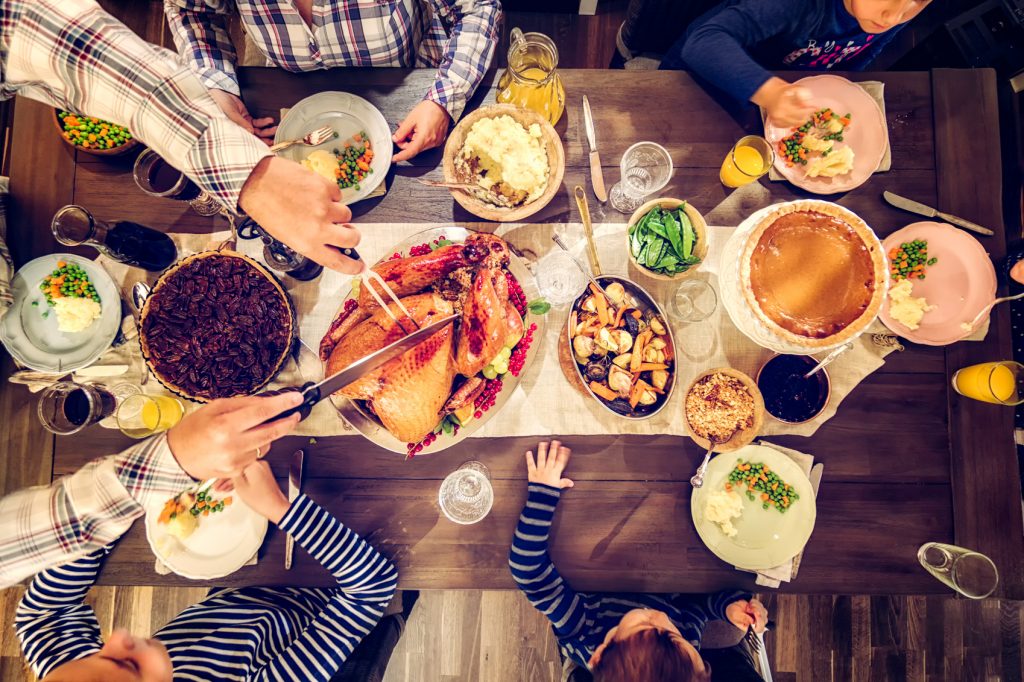 A spread of Thankgiving dishes, including turkey, mashed potatoes, and gravy.