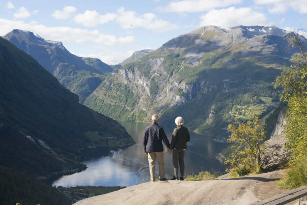 A couple overlooking a fjord in Norway