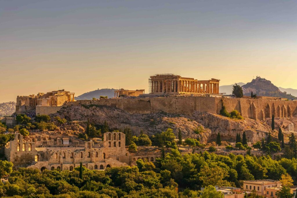 Far away distant view of Acropolis of Athens (a European landmark) in Greece with Parthenon and Erechtheion from Filopappou hill. Herodium, Lycabettus and Acropolis of Athens view from Filopappou hill a summer sunny day
