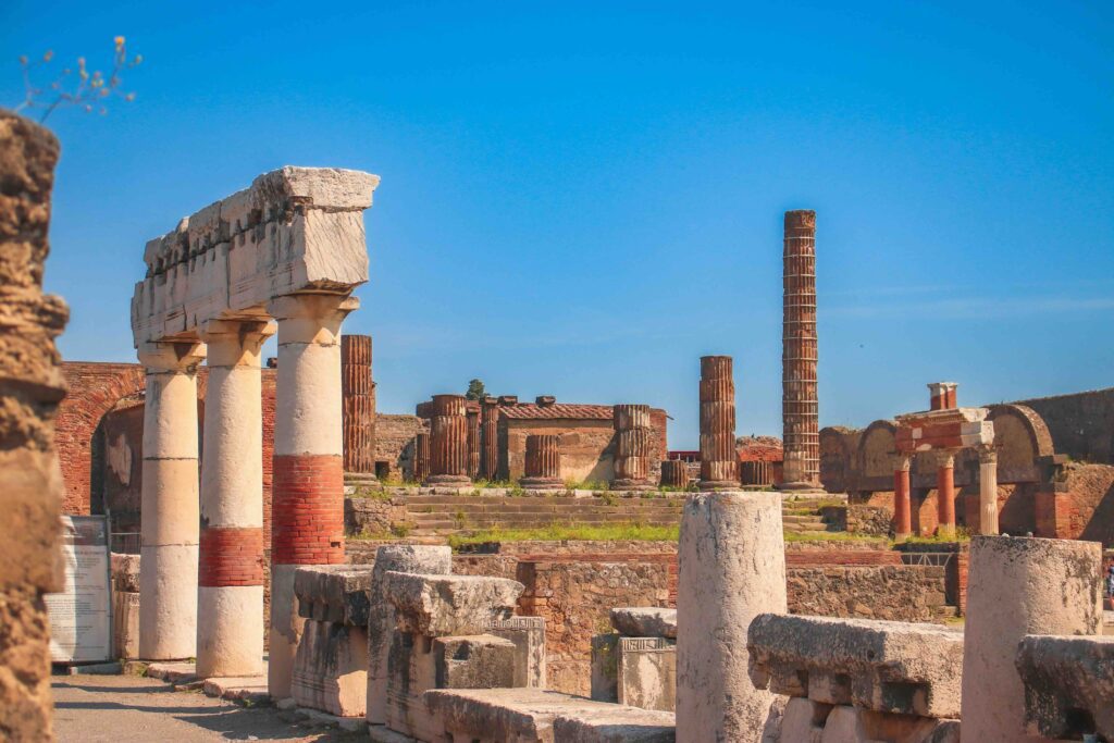 The ancient ruins of Pompeii, Italy, with weathered stone streets, crumbling walls.