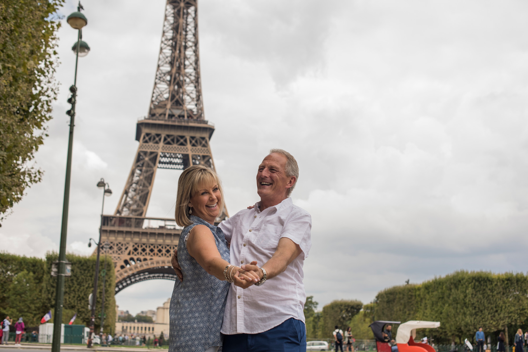 couple dancing beneath Eiffel Tower in Paris