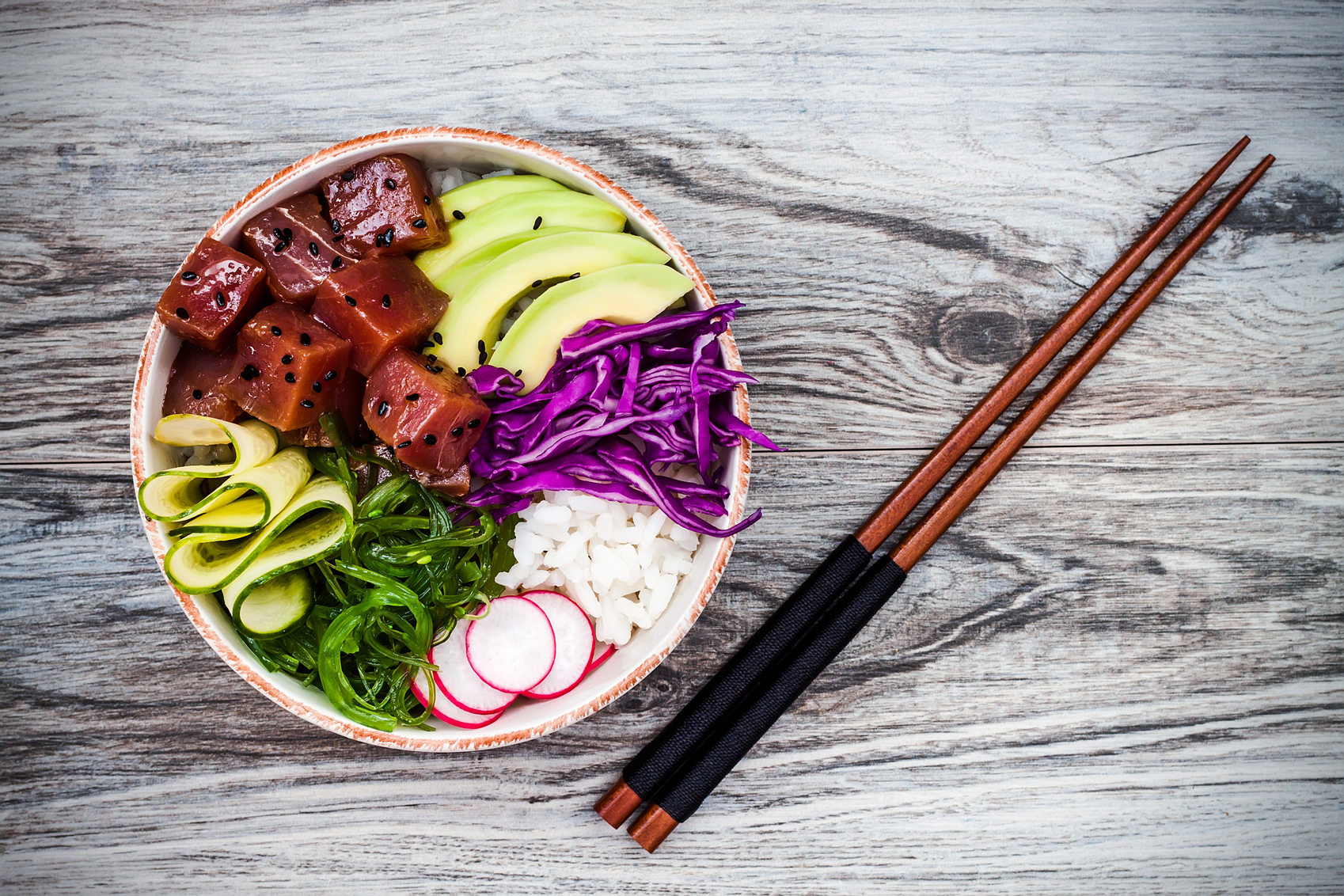 Hawaiian dishes Hawaiian-tuna-poke-www.istockphoto.comgbphotohawaiian-tuna-poke-bowl-with-seaweed-avocado-red-cabbage-radishes-gm583988964-99974259-sveta_zarzamora