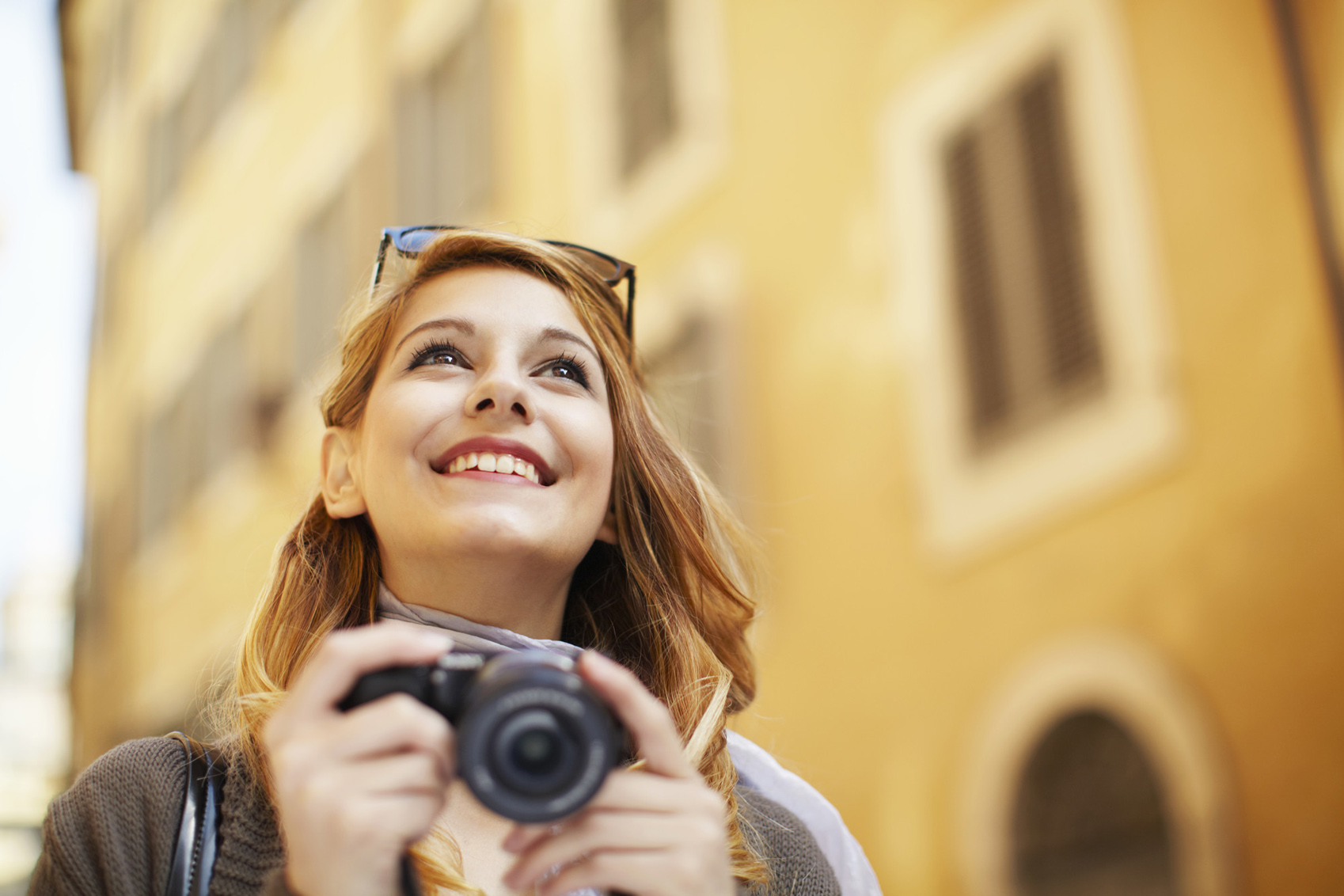 Revisit a Destination Young woman with digital camera, Rome, Italy