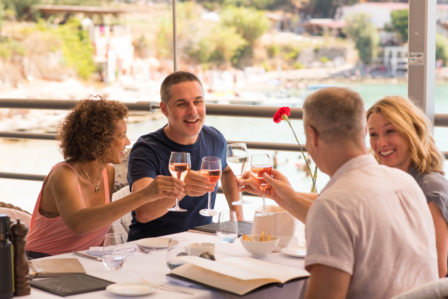 A group of friends saying cheers with a glass of wine