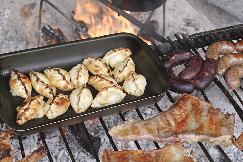 empanadas, steak and choripan on asadao grill in Argentina