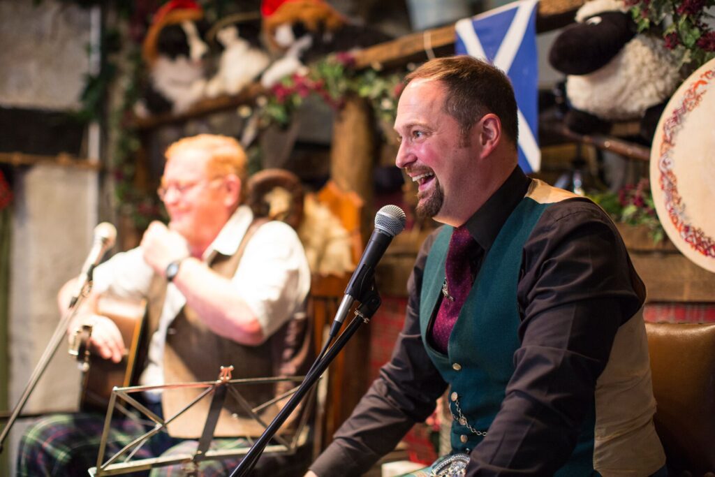 Fergus and Gregor Wood playing music on a Be My Guest experience