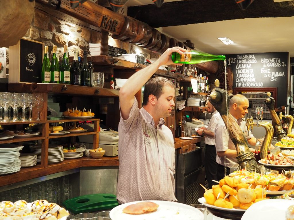Man pouring cider in Asturias