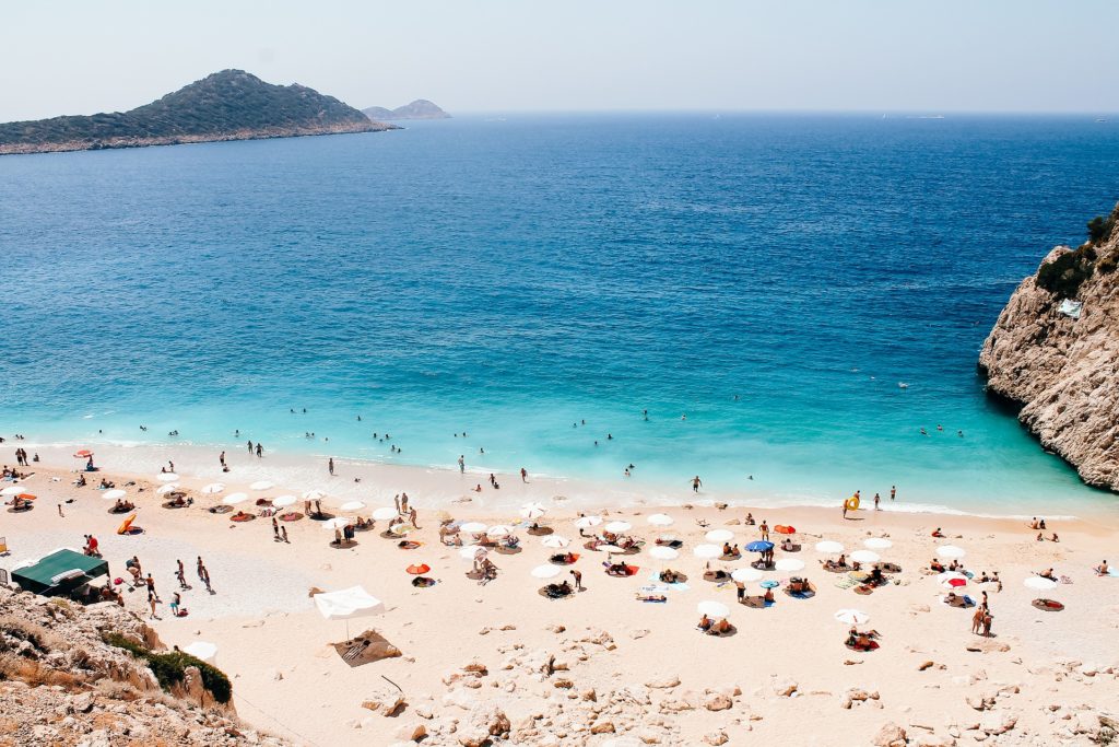 A beach in Turkey crowded with people, perfect for your travel guide.