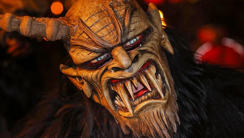 A demon mask with horns that tells the story of St. Nicholas Day.