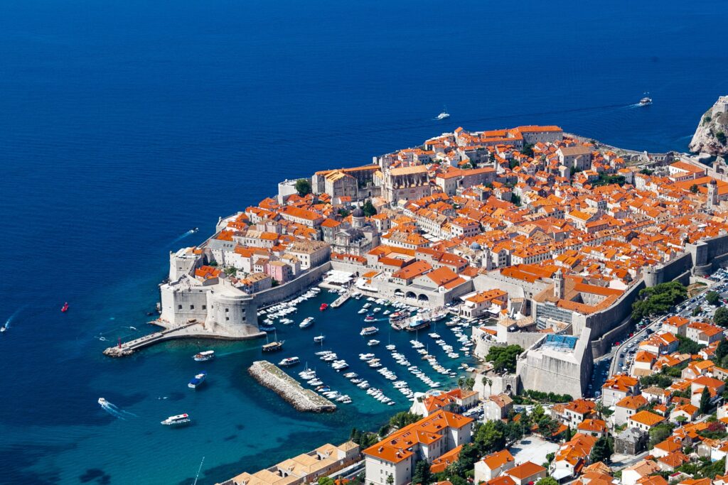 An aerial shot of Dubrovnik in with a deep blue Adriatic ocean in the background