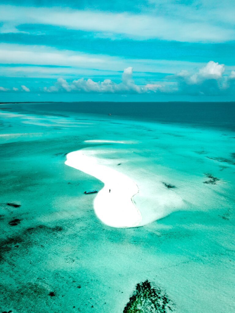 Turquoise waters of the Maldives surround a small sandy strip