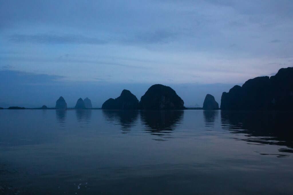 A landscape shot of stones peeking out of the sea