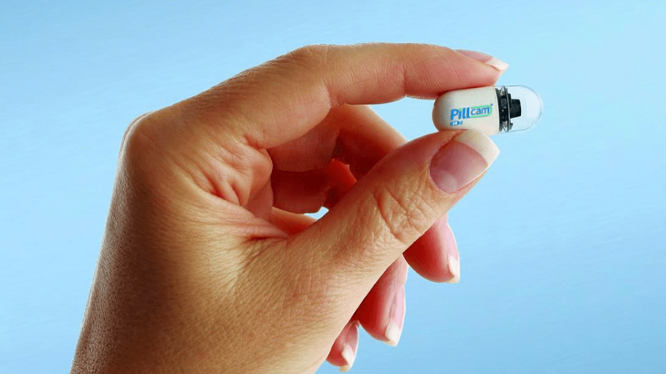 Hand holding the PillCam invented in Israel