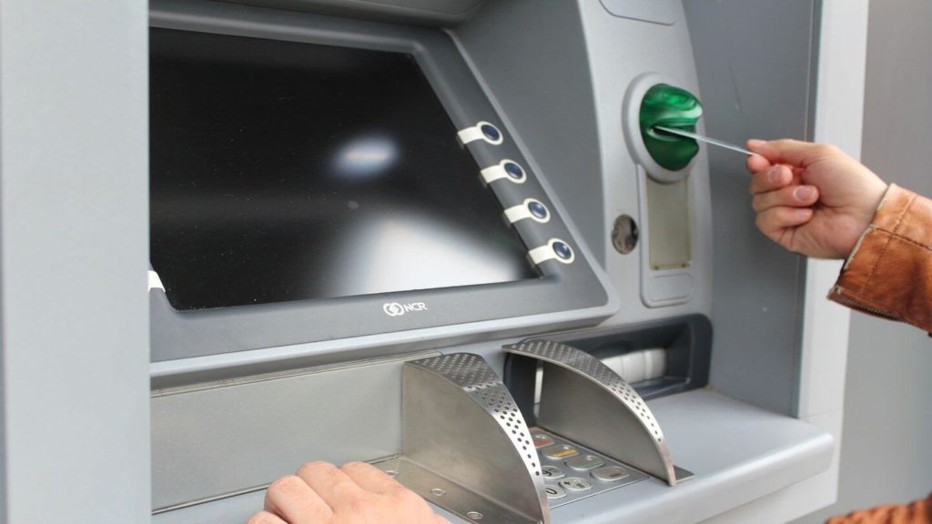 inserting card into ATM machine