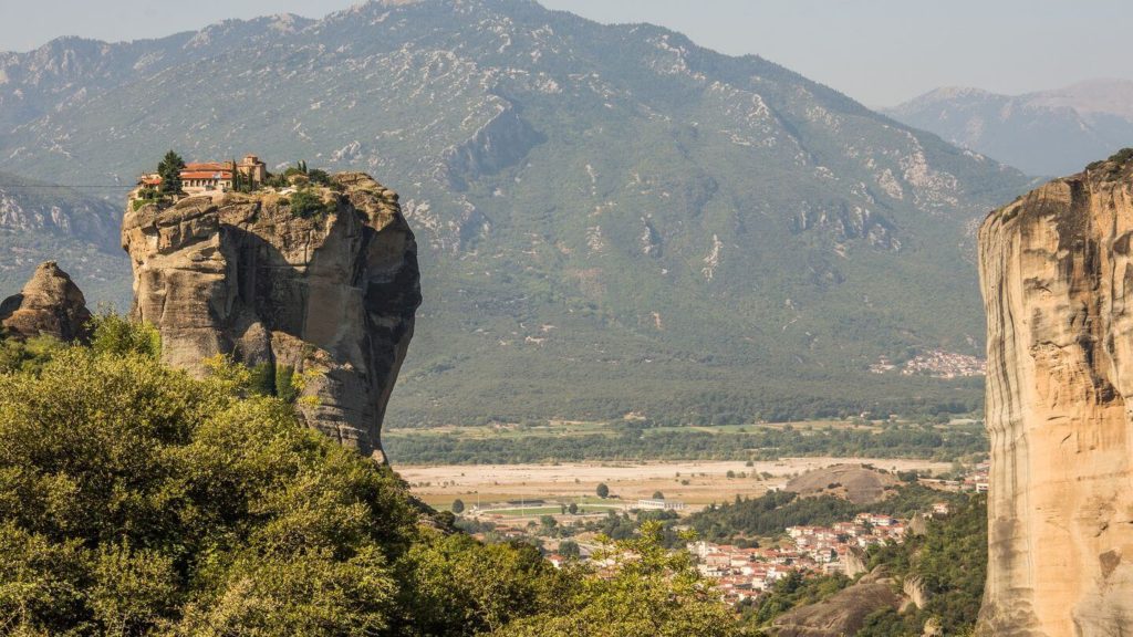 A church perched on a cliff in Greece offers breathtaking views.