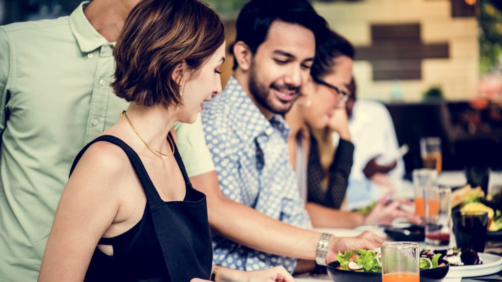 People enjoying traditional Slovenian food and fishes