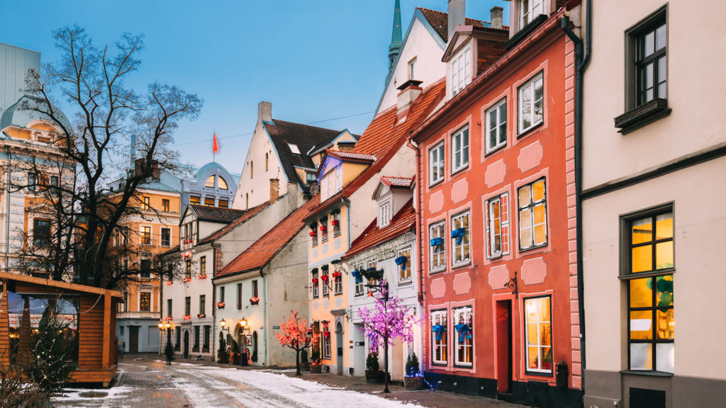 A street lined with colorful buildings in the winter, creating a picturesque scene.