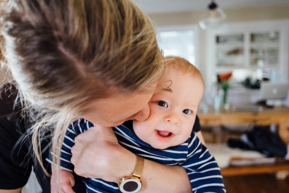 young mum kissing her baby