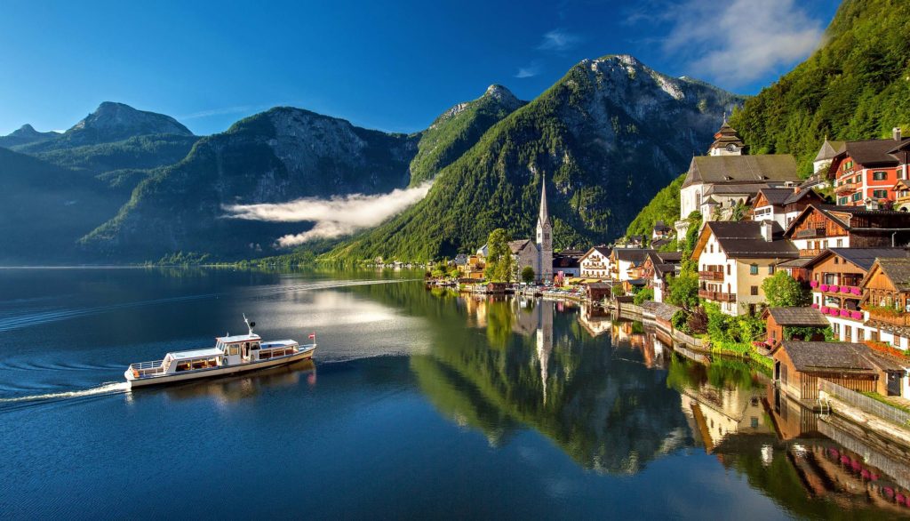 A boat floats in the water, surrounded by the beauty of nature in Austria.