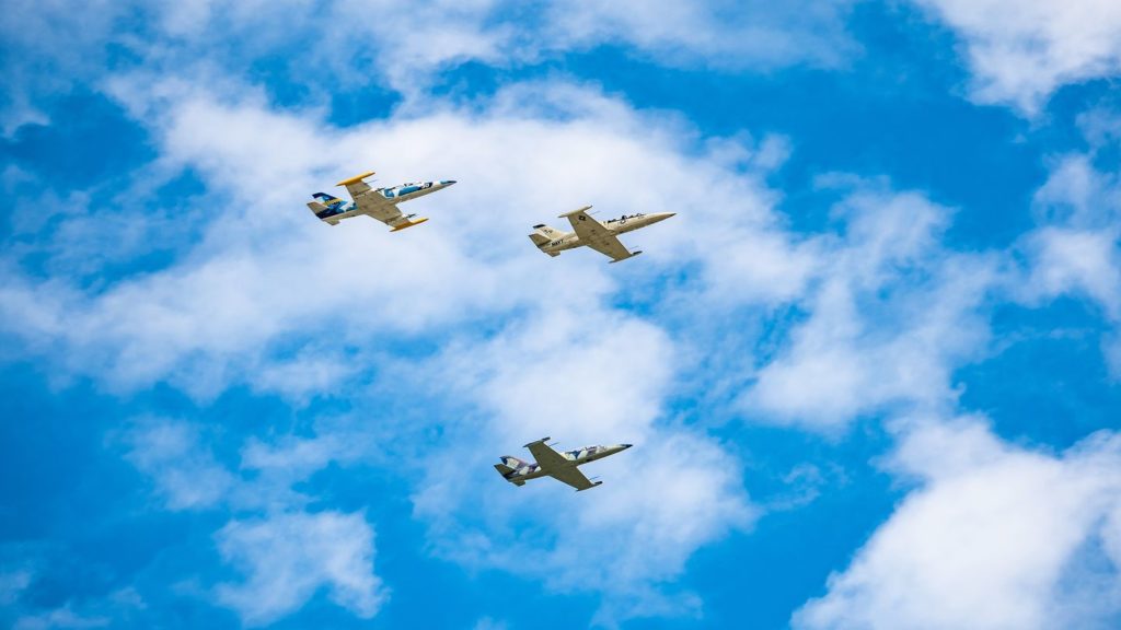 three supersonic planes flying blue skies
