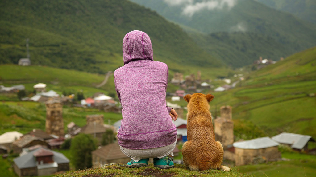 Landscape with a person and a dog watching over the valley - Interesting, fun Georgia country facts