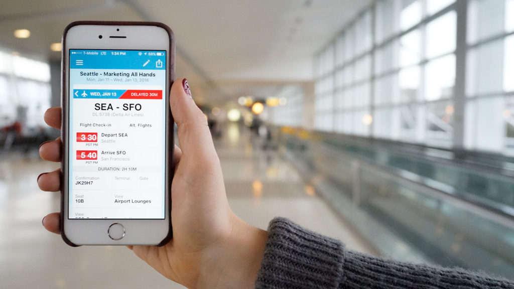 Person holding a phone with travel itinierary