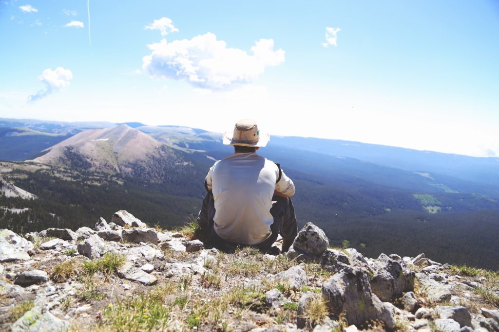 man looking out at view of mountains