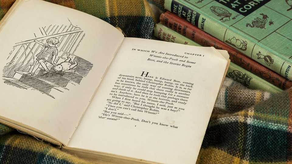 Winnie the Pooh a book on a blanket