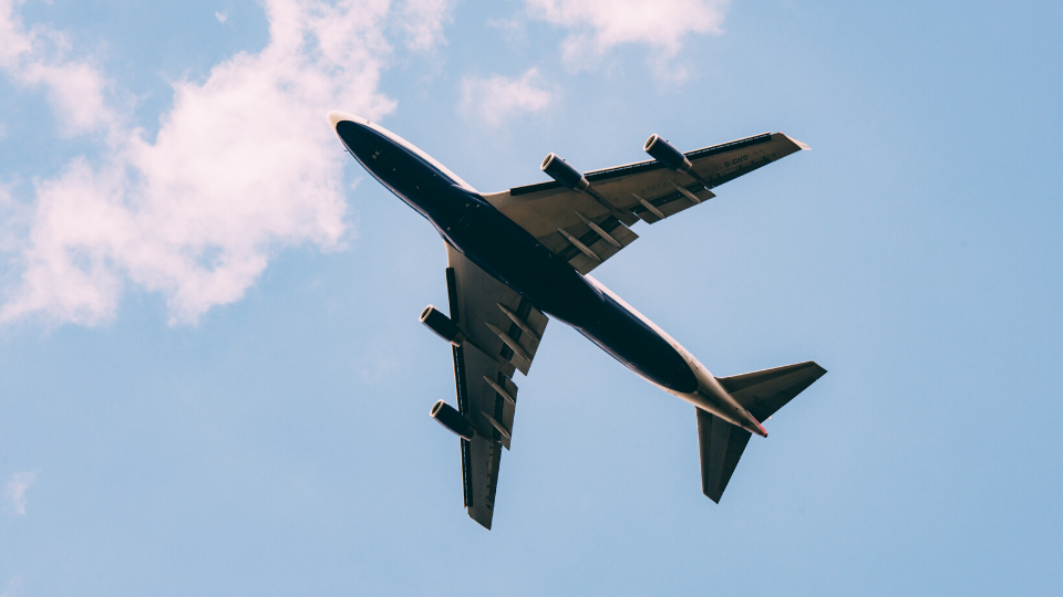plane flying in front of blue sky