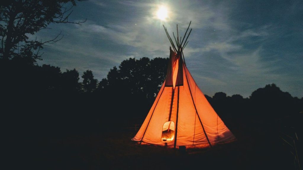 teepee tent illuminated at night travel themed activities
