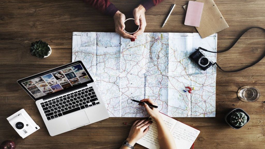 laptop map camera travel planning travel themed activities